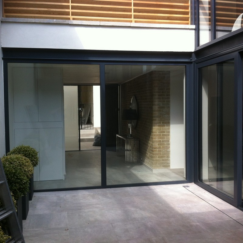 Floor-to-ceiling sliding doors opening to courtyard in Walworth