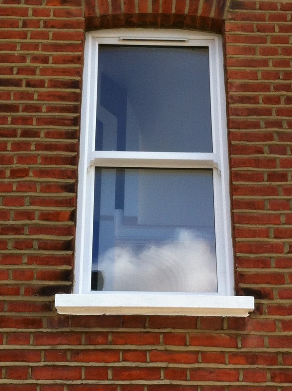 uPVC sash window on Victorian red brick house in Walworth